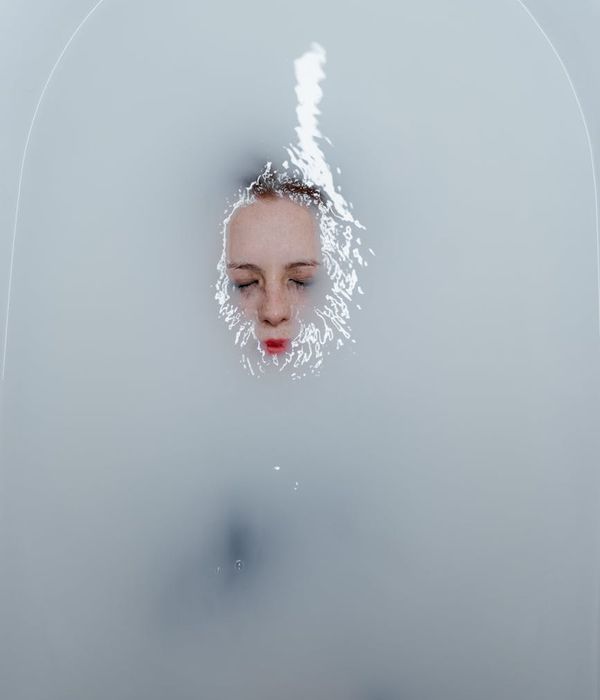 Woman feeling peaceful and energetic in a minimalist room.
